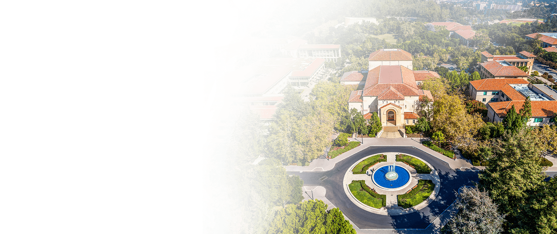 Majestic university building surrounded by lush greenery, showcasing the beautiful campus environment in American colleges.